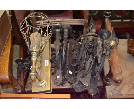 A brass backed wall lamp with a selection of iron wall lamps
