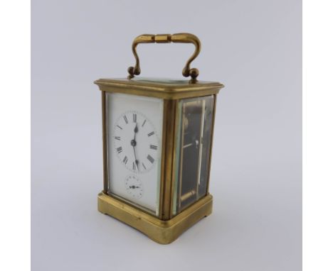 A French carriage alarm clock, late 19th Century, brass corniche case with oval visible escapement window to the cover, white