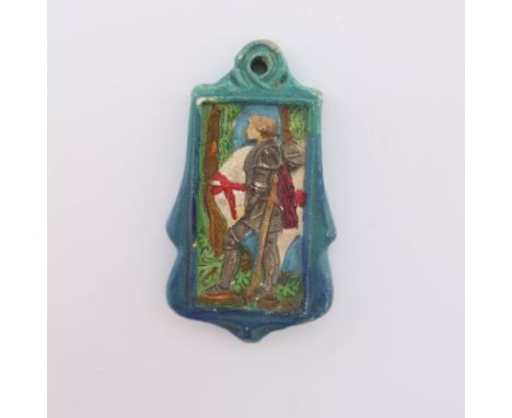 A Compton Pottery pendant, of cartouche form, depicting St George in relief, polychrome decorated with a blue border, height 