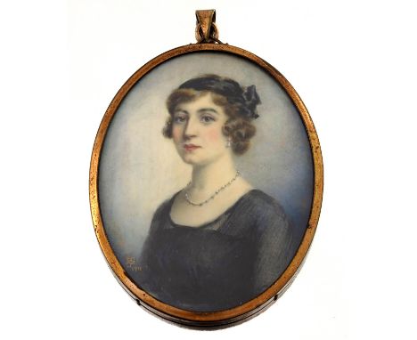 An early 20th century portrait miniature pendant, depicting a lady wearing pearls, watercolour, signed with monogram and date