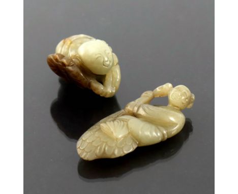 An oriental brown striated jade netsuke, in the form of a crouching boy, length 4cm, with a jade carving of snake charmer, 6c