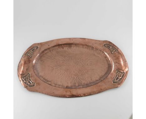 An Arts and Crafts Iona style copper tray, shaped oval form, repousse decorated with Celtic knots to the corners, 57cm long