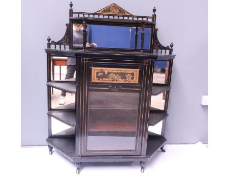 An Aesthetic Movement ebonised and gilt pier cabinet, circa 1880, raised mirror back with shelf and spindle gallery, over a c