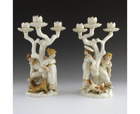 James Hadley for Royal Worcester,   a pair of triple branch candelabra in the style of Kate Greenaway, date cypher for 1884, 