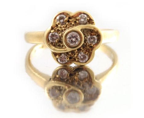 An 18ct gold brilliant-cut diamond floral cluster ring, with slightly tapered band, total diamond weight 0.25ct, engraved to 