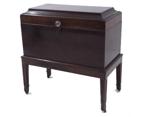 A George III mahogany cellarette, circa 1790, sarcophagus chest caddy from on integrated stand, the chamfered lid hinged and 