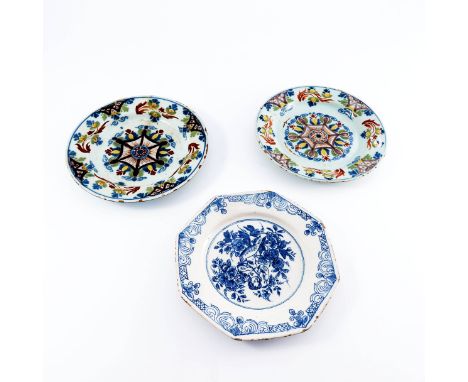 Three various 18th Century English delftware plates, circa 1720-1780, a near pair with polychrome central star decoration and