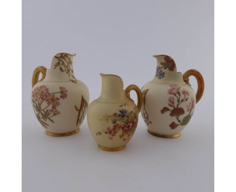 Three Royal Worcester flat back jugs, ivory and blush ivory, painted with flowers and highlighted in gilt, puce marks, 14cm h