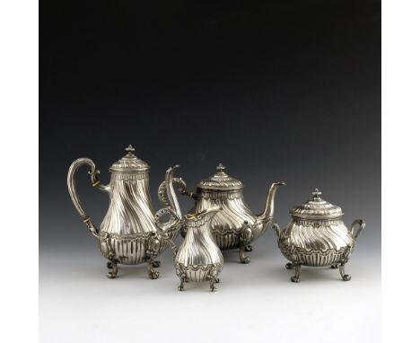 A French silver four piece tea and coffee set, Fray Fils, Paris circa 1890, wrythen fluted baluster form, the bodies chased a