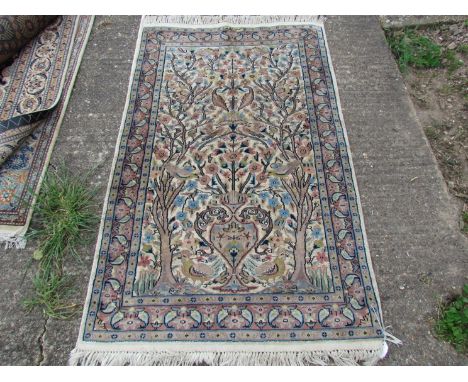 A modern hand made rug, central field decorated with Art Nouveau vase flanked by sprawling trees, 153cm x 95cm   