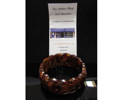 An amber elasticated bangle from The Amber Shop, Southwold, boxed 