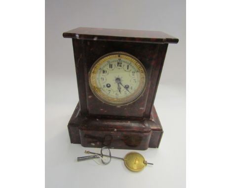 A rouge marble mantel clock with ornate numerated chapter ring 