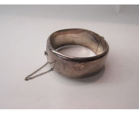 An engraved stiff hinge bangle stamped sterling 