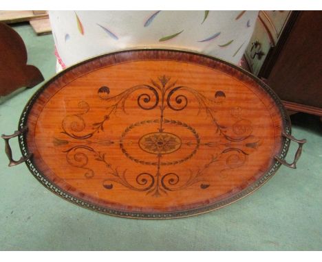 A large satinwood oval tray with ladder edge and inlay