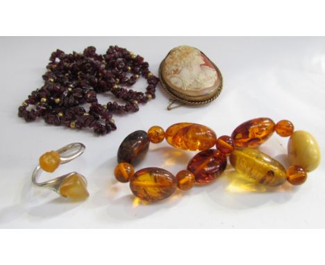 A garnet bead necklace, shell cameo brooch, amber bracelet and ring