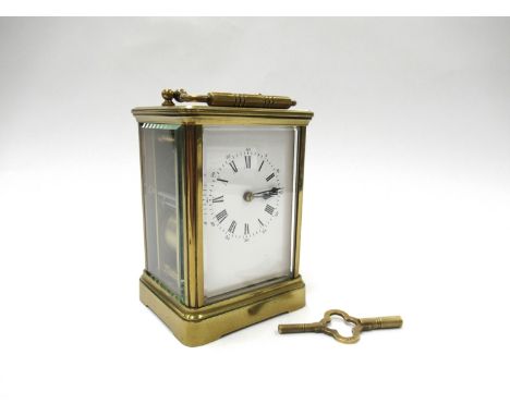 A late 19th early 20th Century French striking carriage clock, enamelled Roman dial rack and snail striking on a coil gong, S