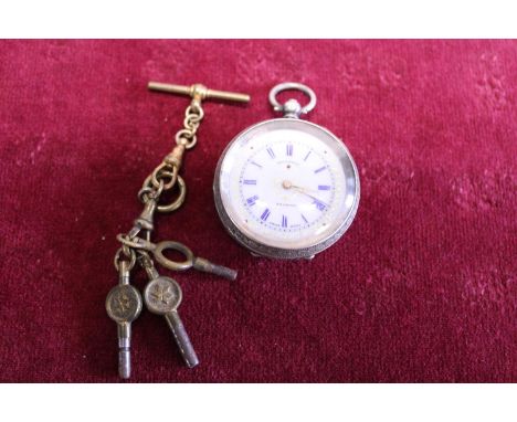 A ladies continental silver pocket watch with enamel dial and keys, works intermittently 