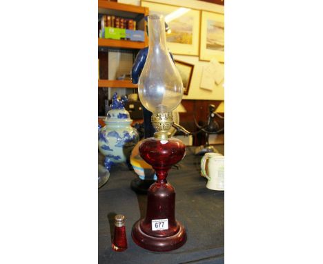 Antique ruby glass oil lamp and ruby glass pepperette