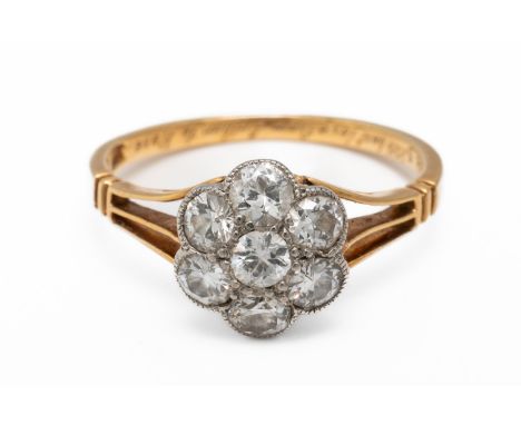 A DIAMOND FLORAL CLUSTER RING (2)Set with seven round brilliant cut diamonds, engraved 'With best love from Arthur to Rose, A