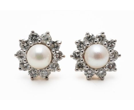 A PAIR OF PEARL AND DIAMOND STUDS (3)The central cream pearl measuring 5.7mm in diameter, in a surround of round brilliant di