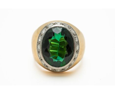 A TOURMALINE AND DIAMOND RINGWith a central oval cut tourmaline measuring 13.2mm x 10.7mm bezel set with a surround of round 