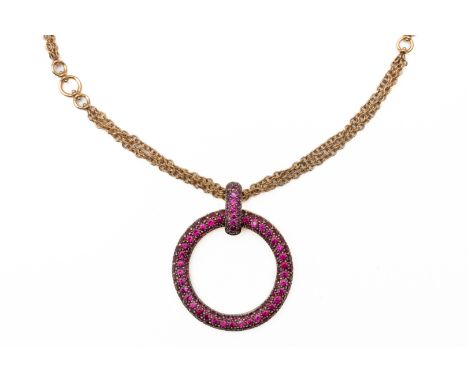 A RUBY PENDANT NECKLACEThe pendant set with round cut rubies, 3cm in diameter, with a ruby set clip bale, on a multi chain ne