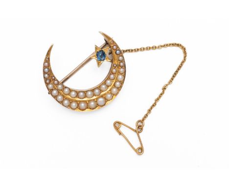 A HALF PEARL AND SAPPHIRE CRESCENT MOON BROOCHSet with two rows of graduating half pearls and a star set with an oval cut sap