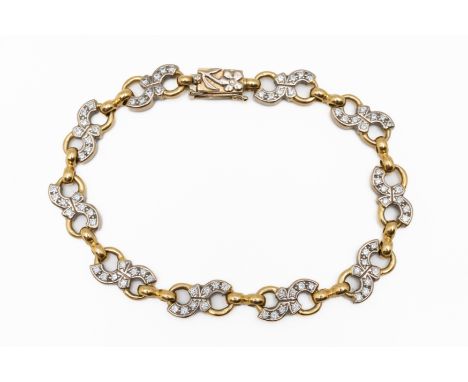 A BICOLOUR DIAMOND SET BRACELETIn 18ct bicolour gold with fancy links set with round brilliant cut diamonds, with a floral bo