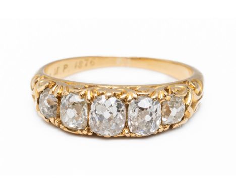 A DIAMOND FIVE STONE RINGMounted with five old cut diamonds, the centre stone weighing an estimated 0.28 carats, with carved 