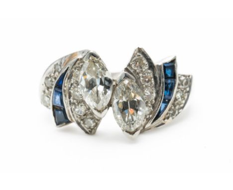 A PLATINUM, DIAMOND AND SAPPHIRE DRESS RINGMounted with two marquise shaped diamonds in a raised design at the centre, otherw