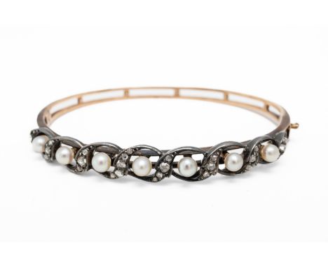 A PEARL AND DIAMOND BANGLESet with cream pearls and motifs of rose cut diamonds, mounted in silver and set to a gold bangle, 