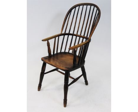 An ash Windsor chair, Lincolnshire, mid-19th century, with simple hoop and stick back and triple ring arm supports, saddle se