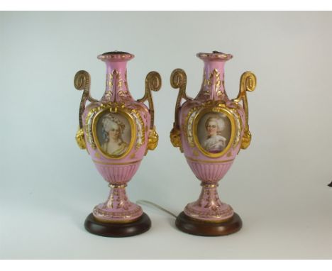 A pair of French porcelain twin-handled vases vases 19th century, the overall pink ground painted with portrait and floral ov