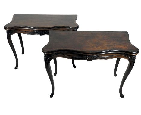 A pair of George III cross banded mahogany and chevron strung serpentine card tables, each with a serpentine fold over top an