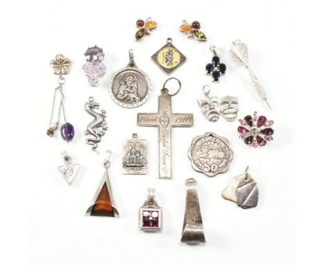 An assorted collection of silver and white metal necklace pendants / charms. The lot to include garnet, amethyst, pearl, ambe