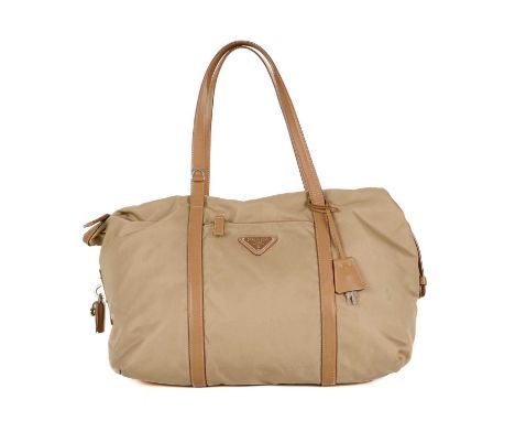 Prada, a nylon tote, designed with a beige nylon exterior, tan leather trim and top handles, front zip pocket, lockable top z