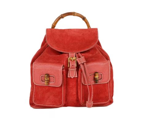 Gucci, a large Bamboo backpack, featuring a red suede exterior with grained red leather trim, curved bamboo top handle, two f