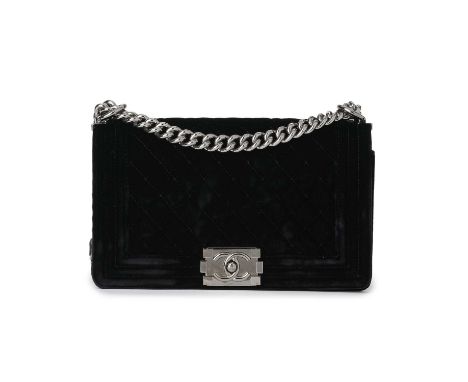 Chanel, a medium velvet Boy handbag, designed with a black velvet exterior, featuring diamond quilting detailing and ribbed b
