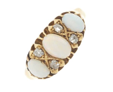 An Edwardian 18ct gold opal cabochon three-stone dress ring, with old-cut diamond double spacers, hallmarks for Birmingham 19