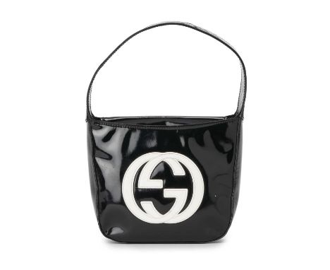 Gucci, a small vintage patent leather handbag, crafted from black patent leather, featuring a central white patent leather do