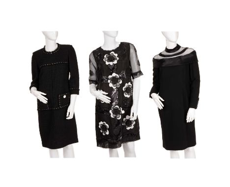 Three vintage dresses, to include a black knee-length dress with sequin embellishment and white and black applique flowers, a
