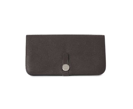Hermes, a 2010 Dogon wallet, crafted from grained chocolate brown Clemence leather, with logo-engraved front button and leath