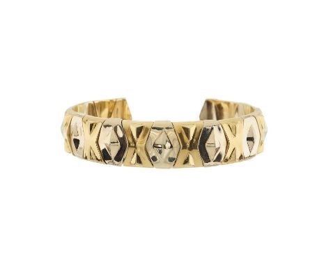 An 18ct bi-colour gold open cuff bangle bracelet, of geometric design, inner diameter 6.3cm, 56.3gOverall good conditionSome 
