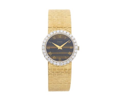 PiagetA diamond set bracelet watch with tiger's eye dialCase: Signed. 18ct gold. Swiss convention marks. Reference 9190A6. Se