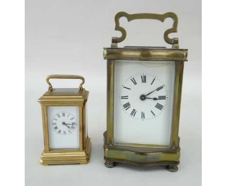 TWO CARRIAGE CLOCKS comprising boudoir carriage clock and another larger (glazed door loose), 7cms, 10cms (2)