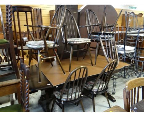 DARK STAINED OAK ERCOL DINING SUITE of trestle table and six dining chairs