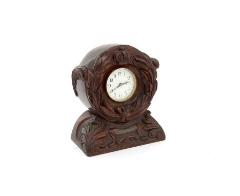 A First World War propeller clock, the twin-bladed propeller carved with a wreath and crown and flanked by wings, centered by