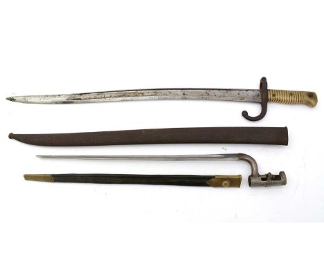 A 19th Century Martini Henri socket bayonet, 1876 pattern, the 42cms triangular blade on metal mount, fitted brass mounted le