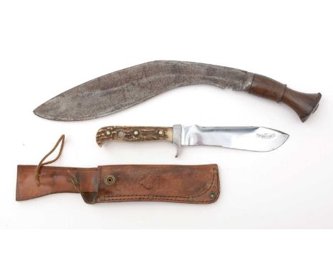 A West German Puma White Hunter knife, the shaped 15cms blade numbered 6377, fitted antler handle, with brown leather scabbar