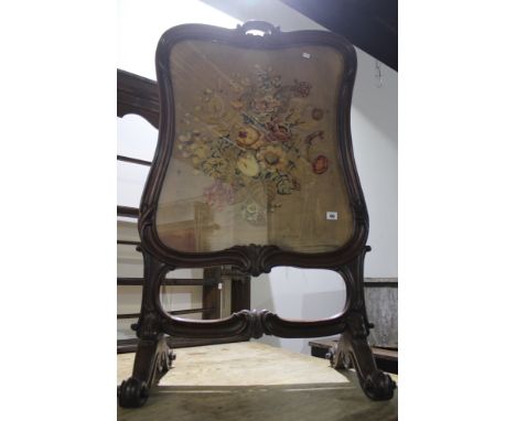 A 19TH.C.CARVED MAHOGANY FRAMED FIRESCREEN WITH NEEDLEPOINT PANEL.